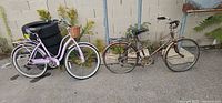 Front view of both cruiser bicycles showing overall condition