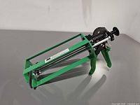 Left side view showing full applicator frame, handle, dual rods