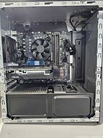 Open side view showing motherboard, GPU, CPU cooler, RAM, SSD, case interior