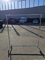 Front view of chrome garment rack fully assembled on pavement