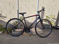 Side profile of Fuji Absolute 2.3 hybrid bicycle leaning against wall