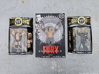 Front view of three sealed WWE Jakks Pacific action figures