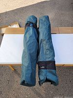 Two teal Kijaro chair carry bags on table