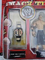 Close-up of John Cena set showing belt watch in blister