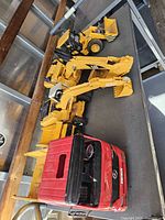 Top view of vehicles showing wheel loader, excavator, dump truck cab and detached bed
