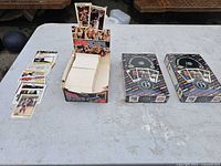 Overview of two sealed hockey boxes, open NBA Hoops box, and loose basketball cards