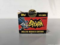 Front view of Topps Batman Deluxe Reissue Edition trading cards box showing logo, price and wear