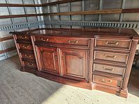 Front view of sideboard showing drawers, doors, finish and hardware