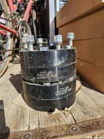 Two stacked black wheel spacers showing side markings, studs, and nuts