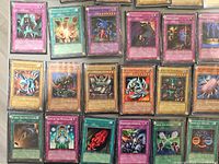 Overhead of sleeved cards showing mix of Monster, Spell and Trap with notable titles visible