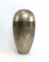 Full front view of bullet-shaped metal vase