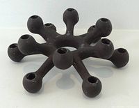 Side view of black cast iron starburst candle holder