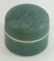 Overall view of closed porcelain box showing celadon glaze and textured lid