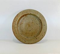 Front of round speckled stoneware plate