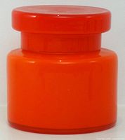 Front view of assembled orange cased glass canister