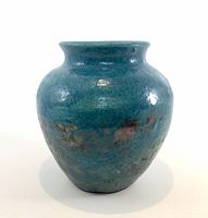 front view of metallic blue glazed ceramic vase