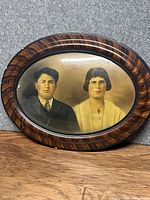 Full view of oval convex glass frame with portrait