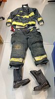 Full suit laid out: jacket, pants, pair of boots
