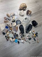 Entire spread of assorted mineral and gemstone pieces on floor