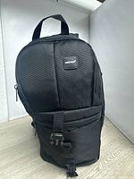 Front view of black NEEWER backpack showing logo, zippers, buckle
