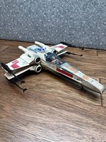Top view of X-Wing Fighter showing overall condition and included Luke figure in cockpit