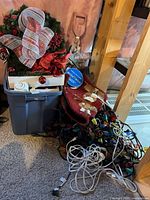 Pile showing wreath, tote, tree skirt, lights, cords