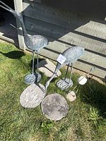 Overall view showing two metal crane statues, stepping stones, and decorative stake