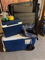 Group shot showing coolers, lounge chairs, lantern, folding chair, citronella candle
