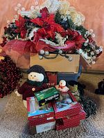 Swag, snowman plush, ornament boxes, lights, bead garland visible