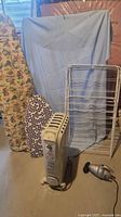 Group shot showing both ironing boards, drying rack, heater, hand vacuum