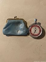 Front view of stopwatch and purse