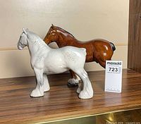 Both ceramic horses side by side