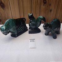 Front view of buffalo, squirrel and bear figurines