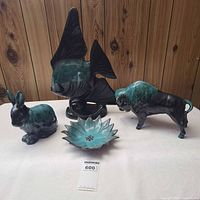 Group view of four Blue Mountain Pottery pieces: sunfish, bunny, buffalo, and starburst dish