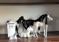 Group shot of all five horse figurines displaying relative sizes and colours