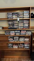 Wide view of multiple shelves filled with stacked DVD cases