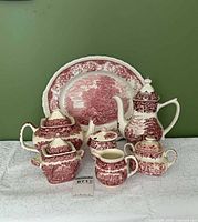 Group shot of all transferware pieces including platter, teapot, coffee pot, sugars, creamer and plate