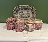 Front view showing platter, two canisters, round jar, square jar