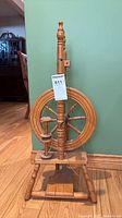 Front view showing overall spinning wheel, drive wheel, treadle and turned hardwood construction