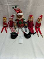 Front view of all seven elf dolls lined in a row