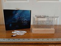 Panel, base, cable and box with ruler for scale