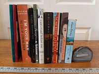 Full group view of ten books standing vertically with agate geode slice at right
