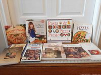 All ten cookbooks arranged on table showing covers
