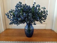 Full view of floral arrangement in vase on table