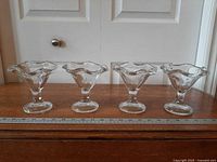 Four dessert glasses side view with ruler for scale