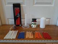 all candles and holder arranged on table with ruler for scale