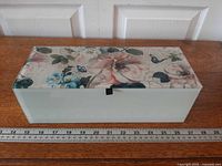 Top view showing floral butterfly design and overall length with ruler