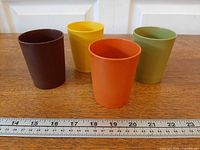 All four tumblers front view with ruler for scale