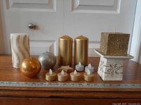 Full group of assorted candles with measuring tape for scale