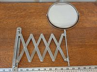 Mirror head and fully extended accordion arm with ruler for scale